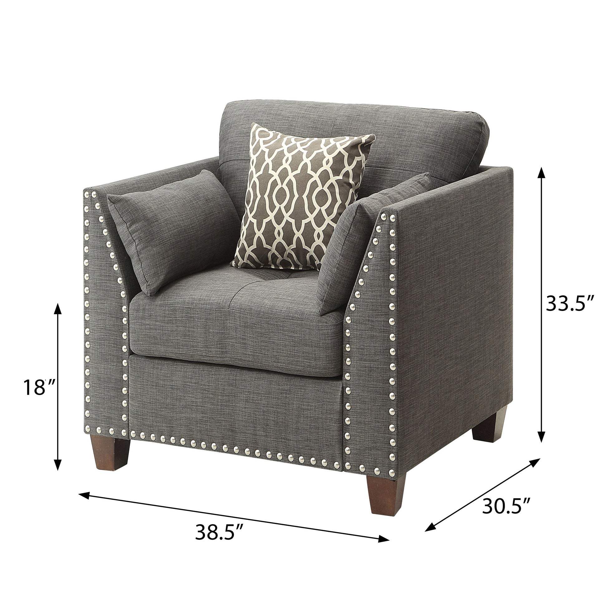 Dark gray fabric accent chair with silver nailhead trim and patterned throw pillow