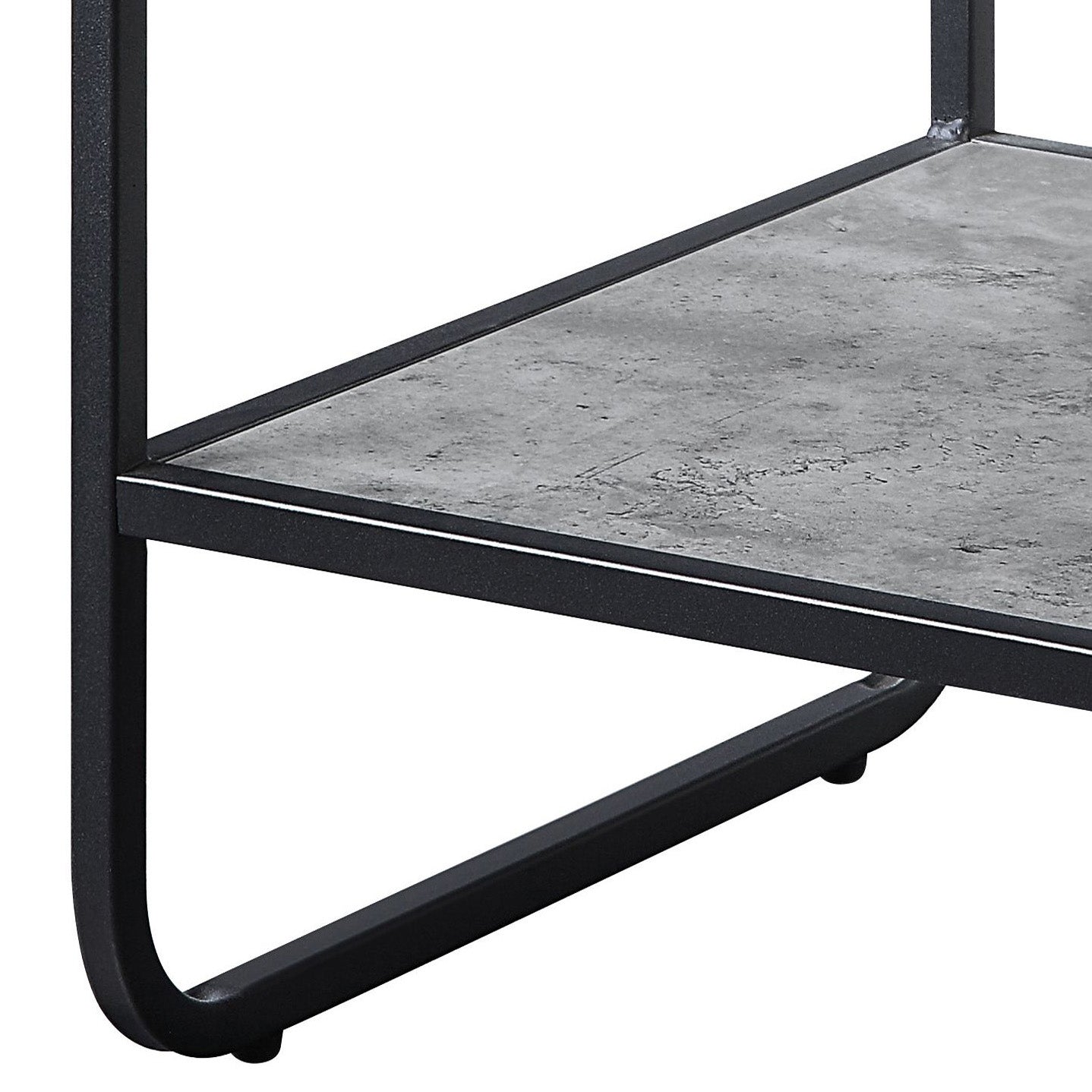 Closeup of a black metal frame side table with a faux concrete shelf