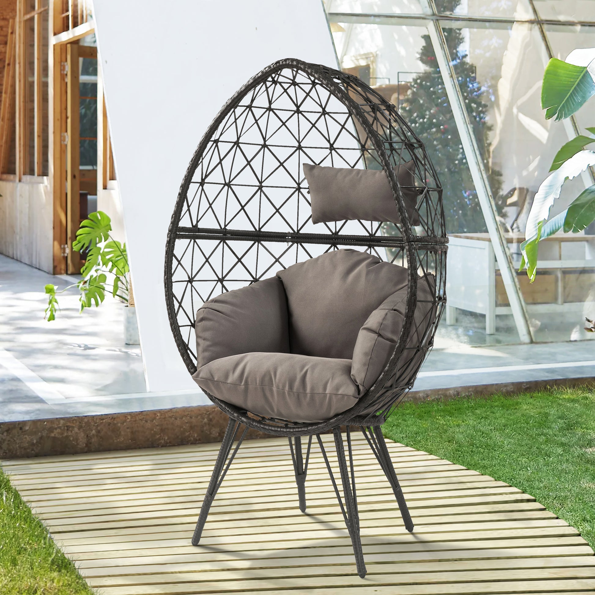 Rattan egg chair with plush grey cushions perfect for outdoor relaxation