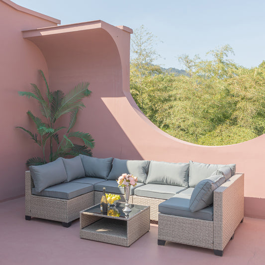 Grey cushioned sectional rattan patio sofa with glasstop coffee table