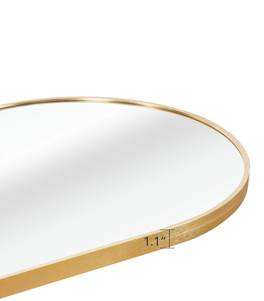Closeup of a golden metal framed oval mirror displaying its subtle brushed texture and inch depth