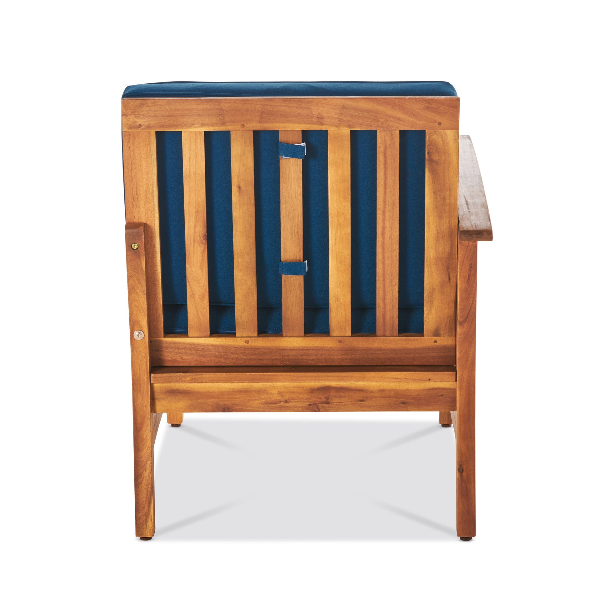 Rear view of a brown acacia wood armchair with a blue cushion featuring a slatted back design