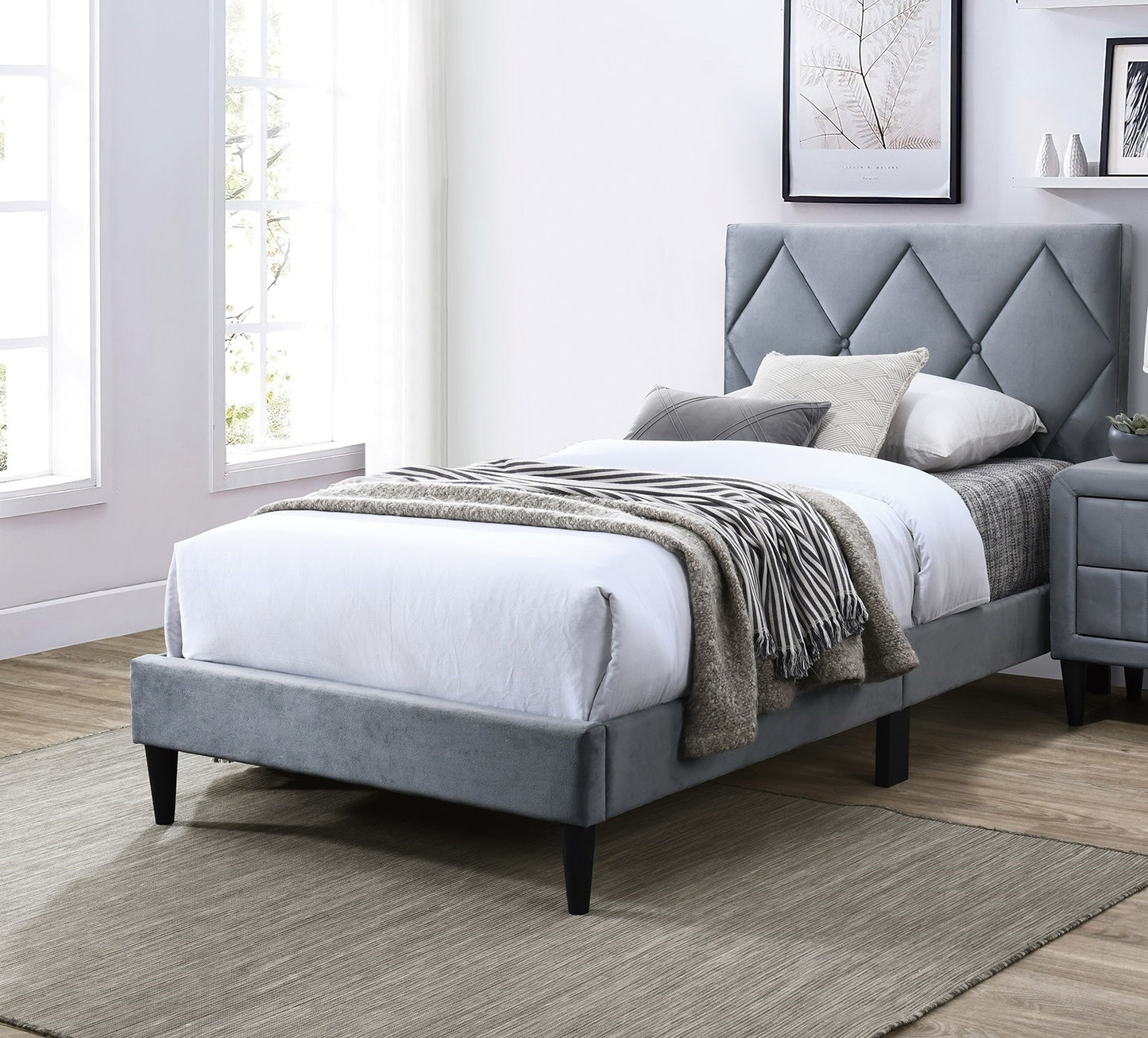 Upholstered grey platform bed with diamondtufted headboard
