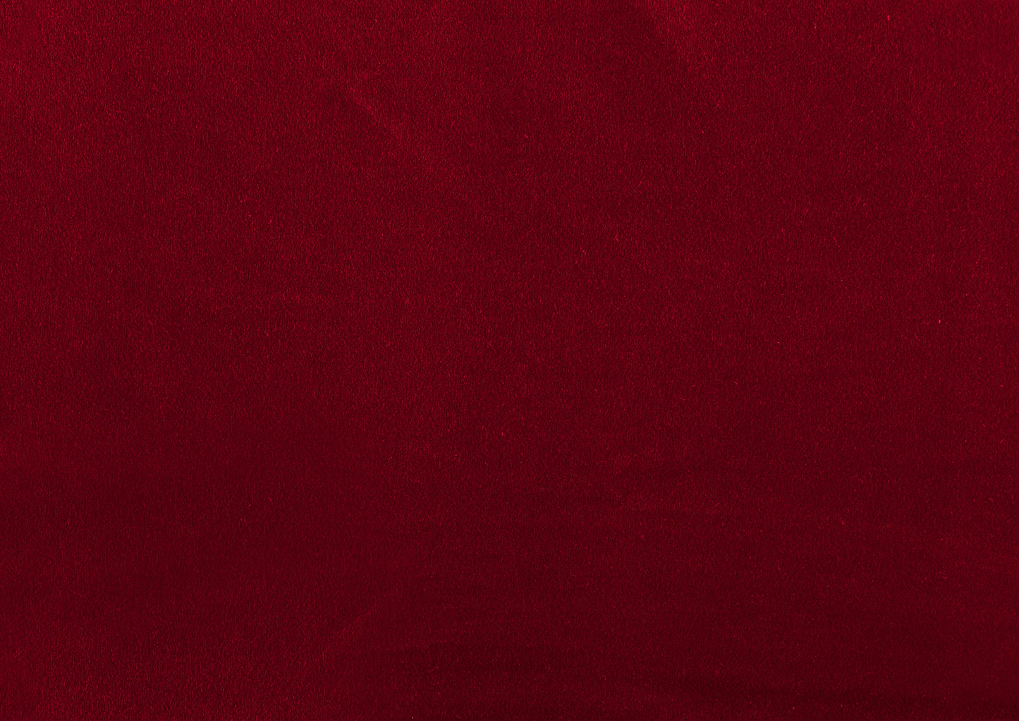 Rich deep red velvet fabric texture for luxurious upholstery applications