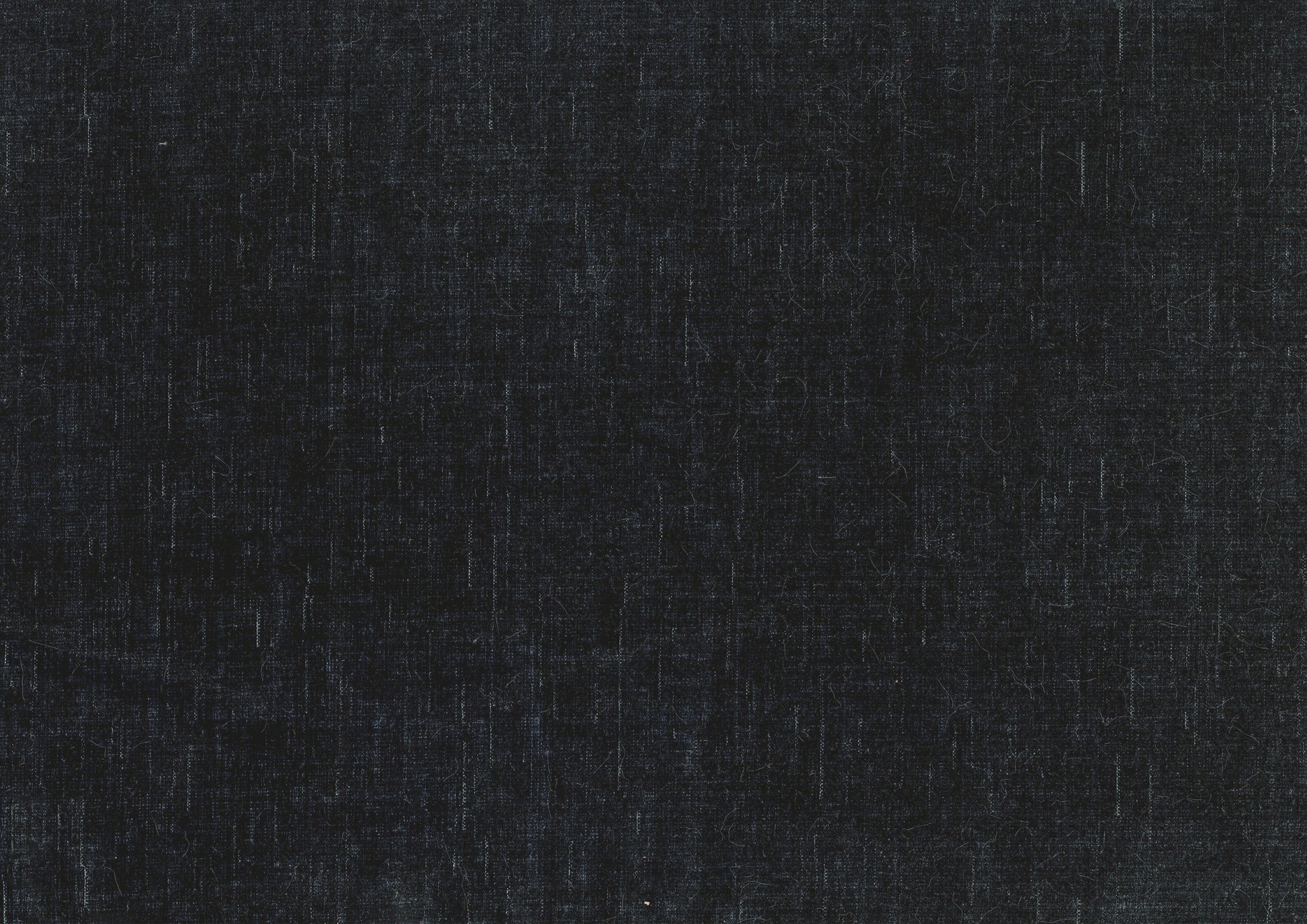 Closeup of a dark grey textured fabric with visible weave ideal for upholstery