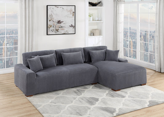 Gray corduroy sectional sofa with plush pillows on a geometric rug