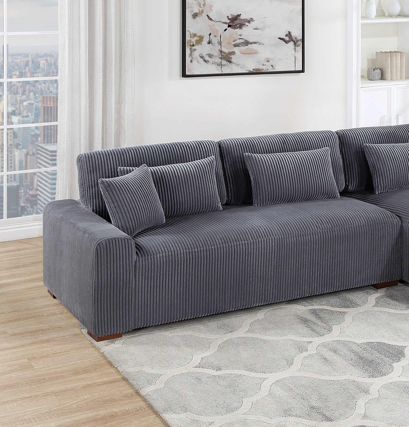 Gray corduroy sectional sofa with plush throw pillows ideal for living rooms