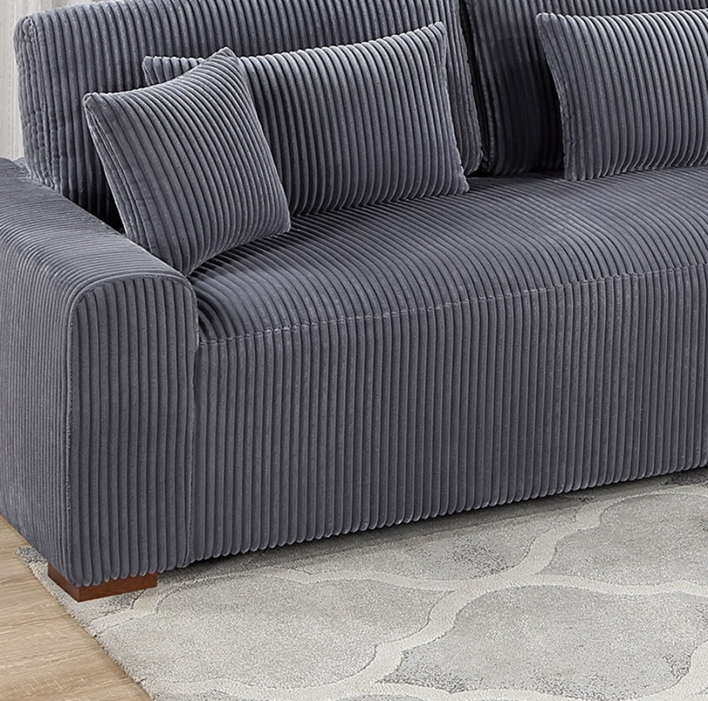Plush charcoal grey corduroy sectional sofa with matching throw pillows