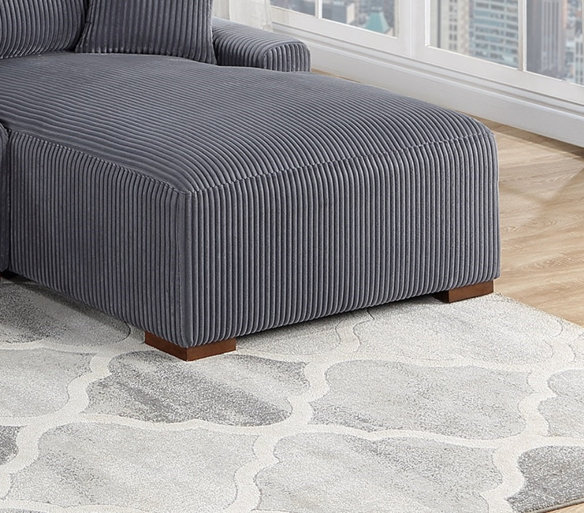 Close up of a grey corduroy chaise lounge ottoman with wooden feet