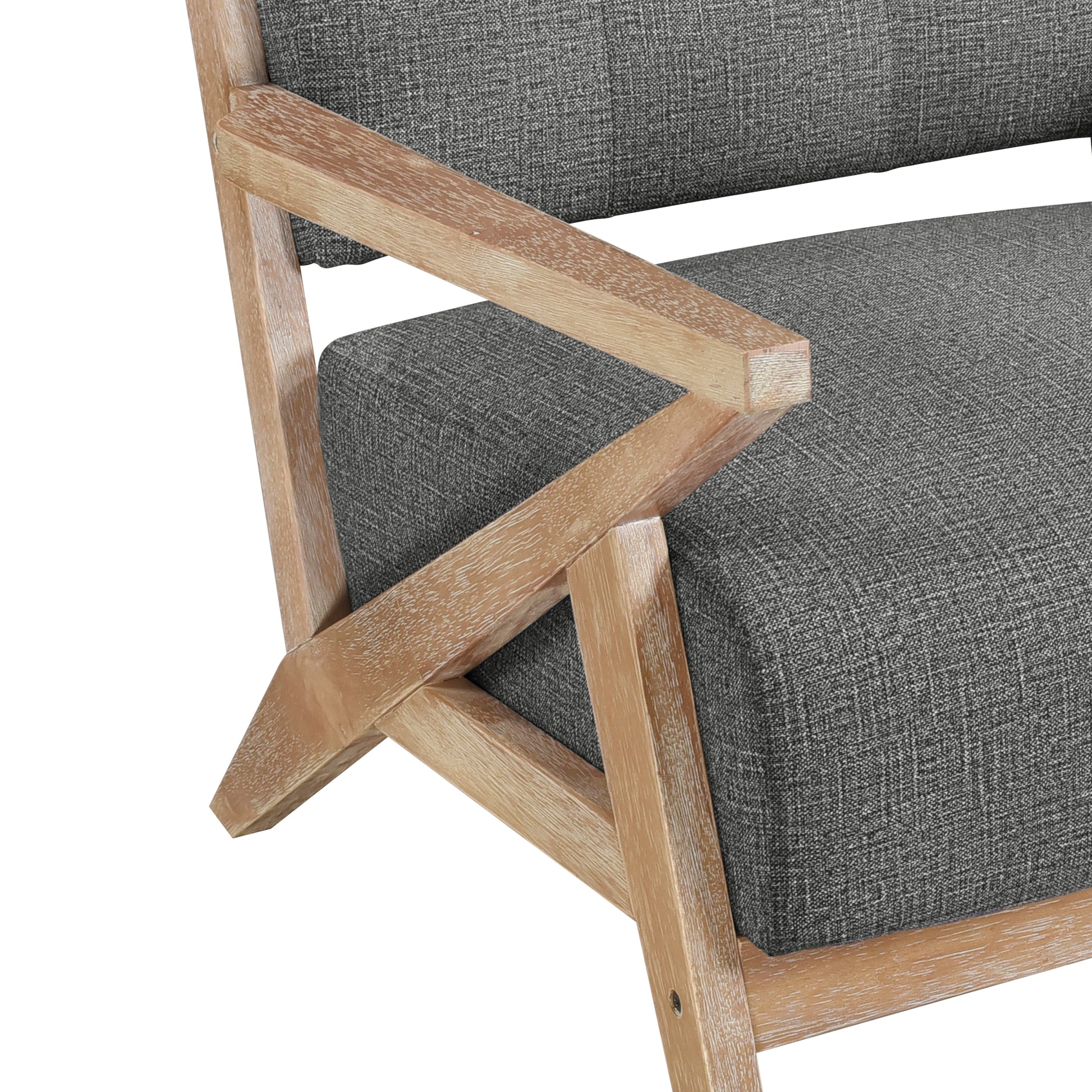 Closeup of a modern grey fabric armchair with a light wood geometric frame