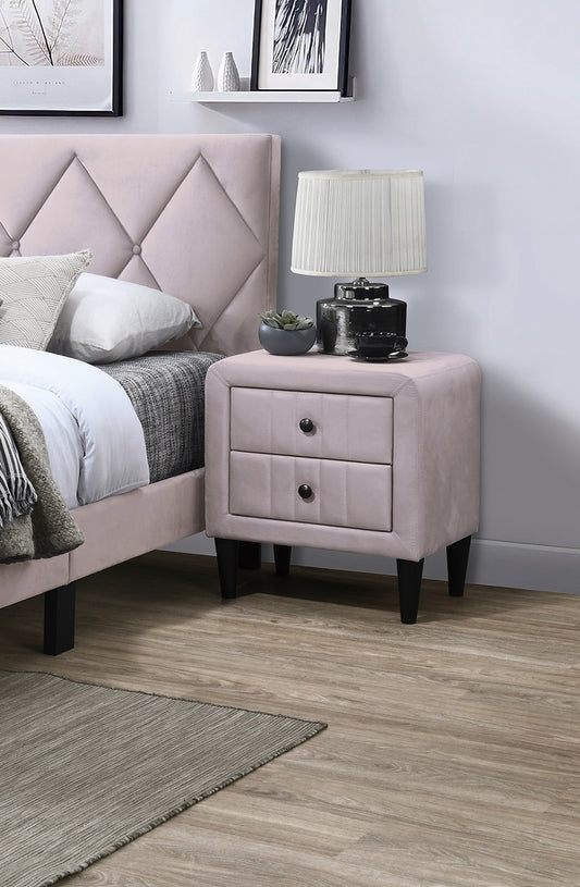 Upholstered blush pink nightstand with two drawers and black hardware