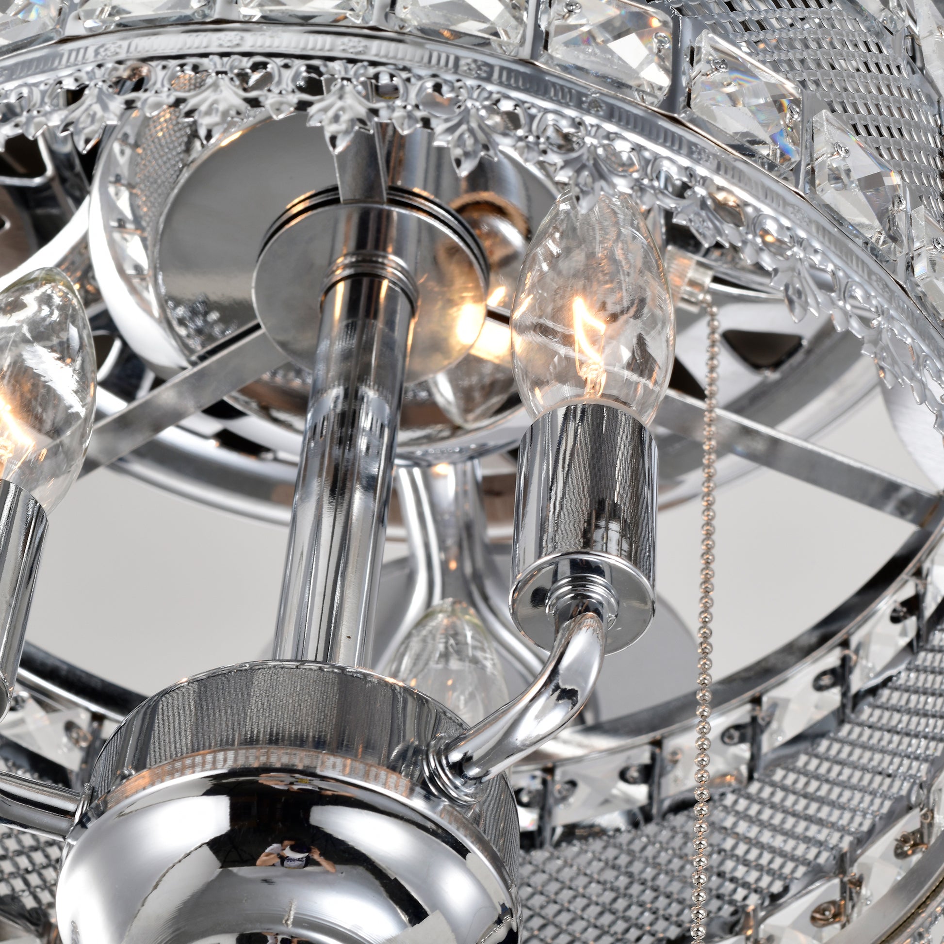 Close up of a chrome chandelier with crystal accents and exposed bulbs showcasing intricate detailing
