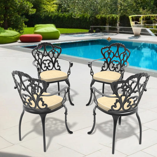 Black cast aluminum patio chairs with beige cushions arranged poolside
