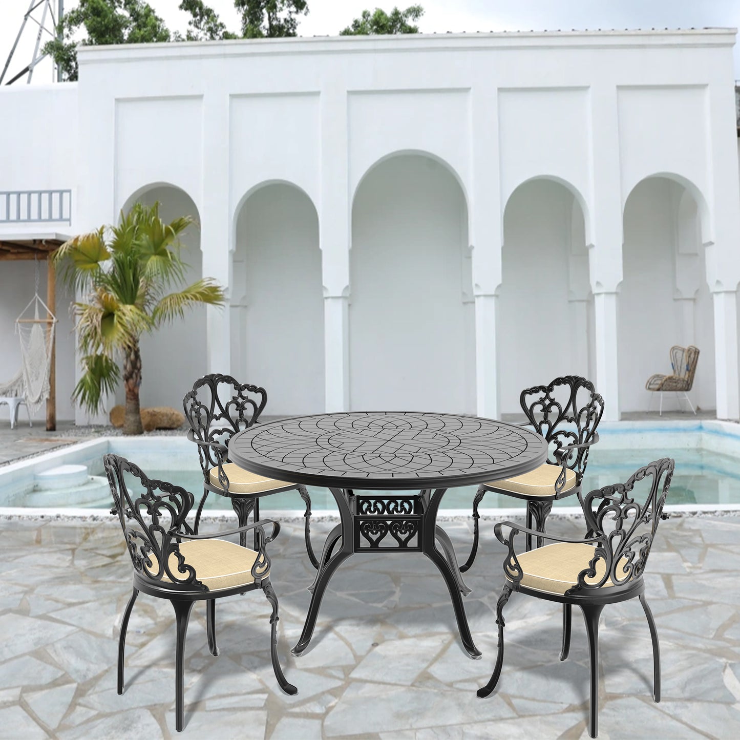 Ornate black cast aluminum outdoor dining set with round table and four chairs