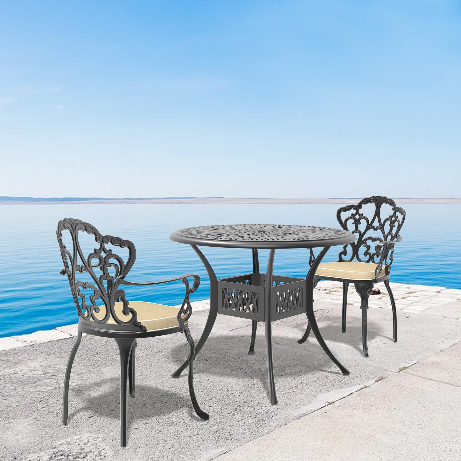 Ornate dark gray cast aluminum patio dining set with cream cushions