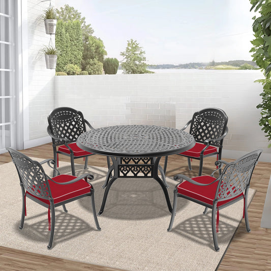 Ornate black cast aluminum patio dining set with red cushions for outdoor seating