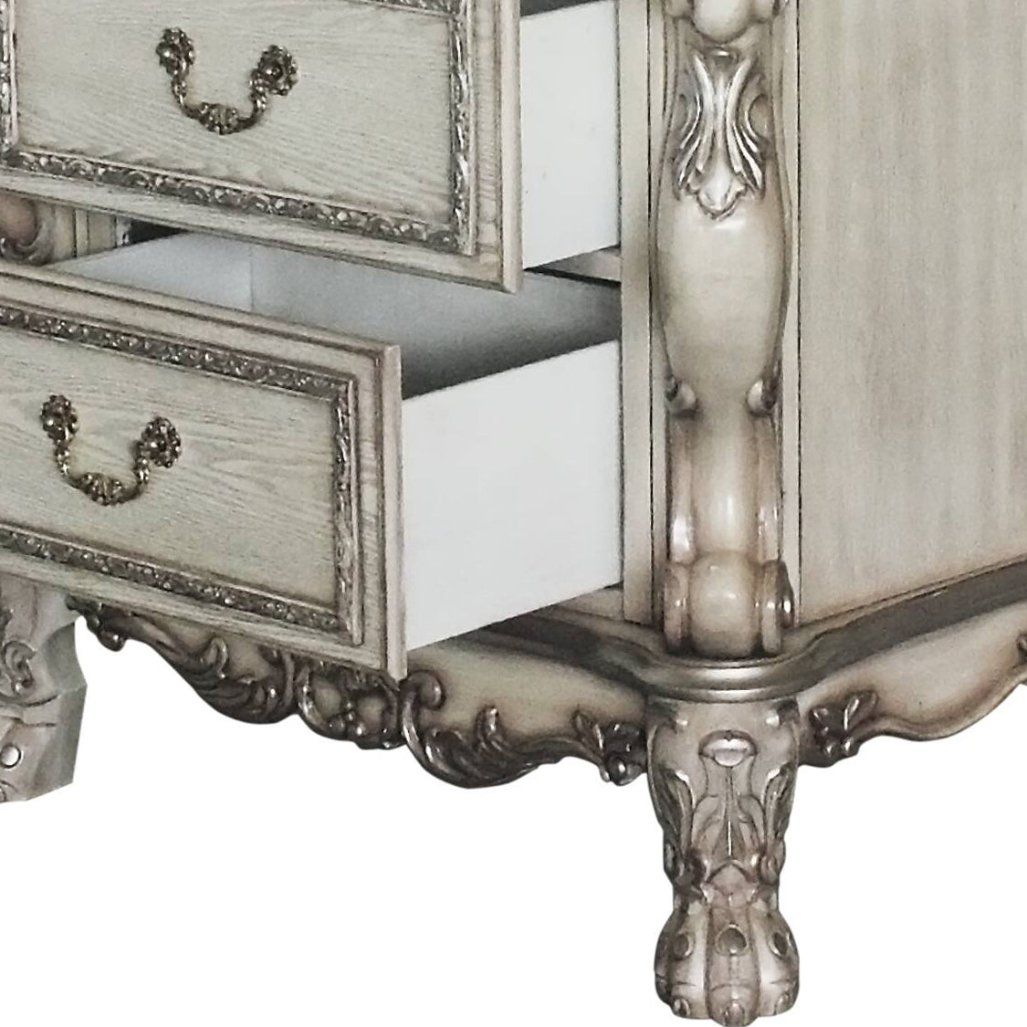 Antique white wooden dresser with ornate drawer pulls and carved legs