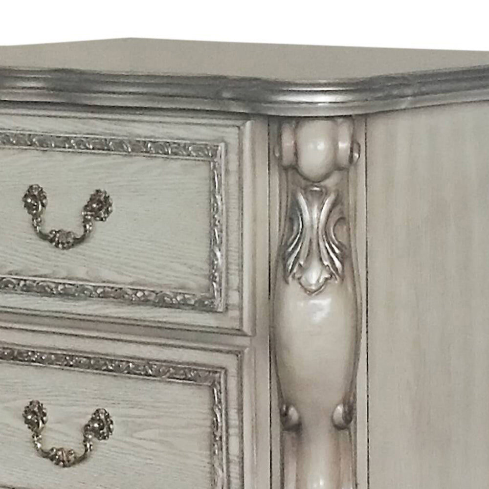 White and silver ornate dresser with decorative drawer pulls