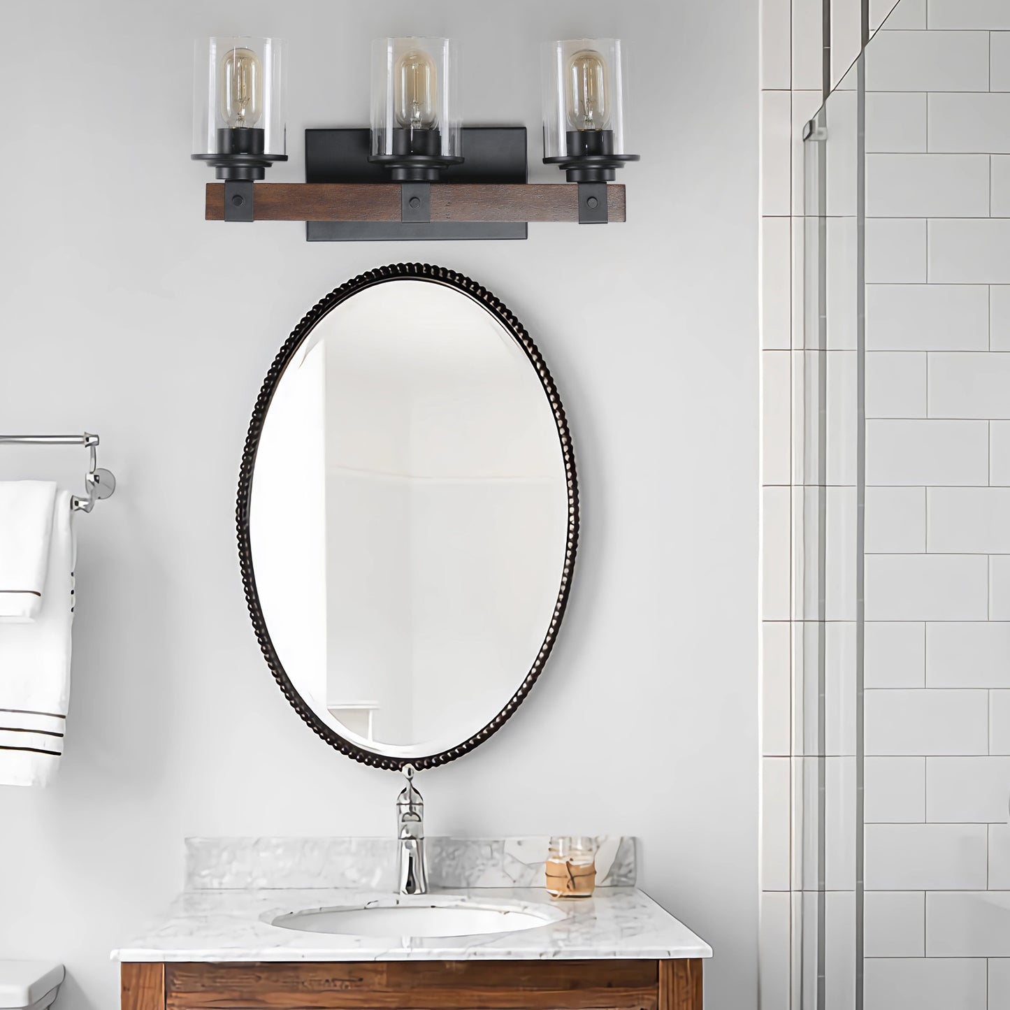 Rustic wood and metal vanity light fixture with three glass shades