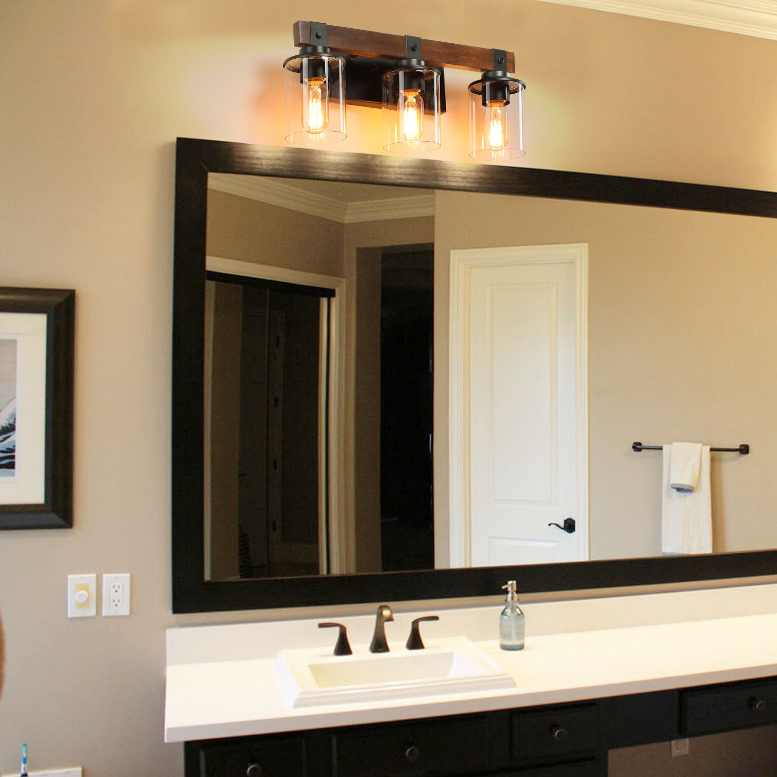 Rustic wood vanity light with three glass cylinder shades and Edison bulbs