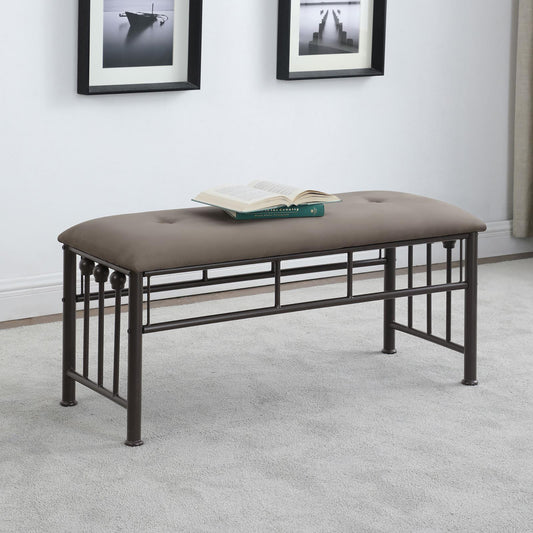 Tufted grey upholstered bench with dark metal frame and decorative finials perfect for entryway