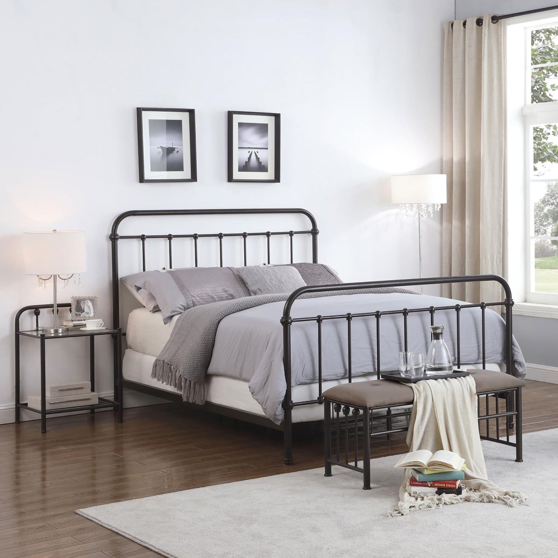 Black metal bed frame with ornate posts and grey linens perfect for modern bedrooms
