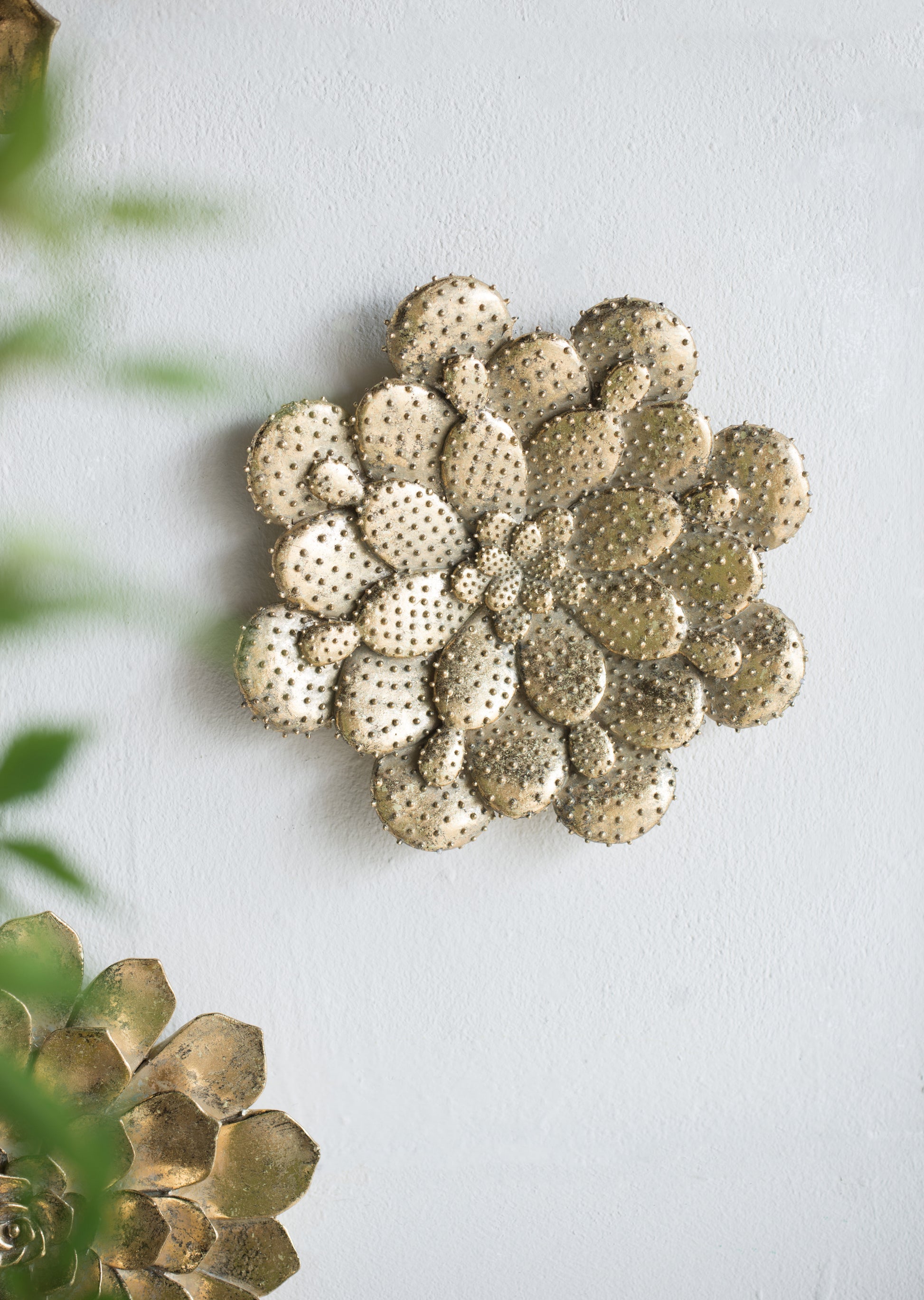 Gold metal succulent wall art with embossed texture adding desert charm to any room