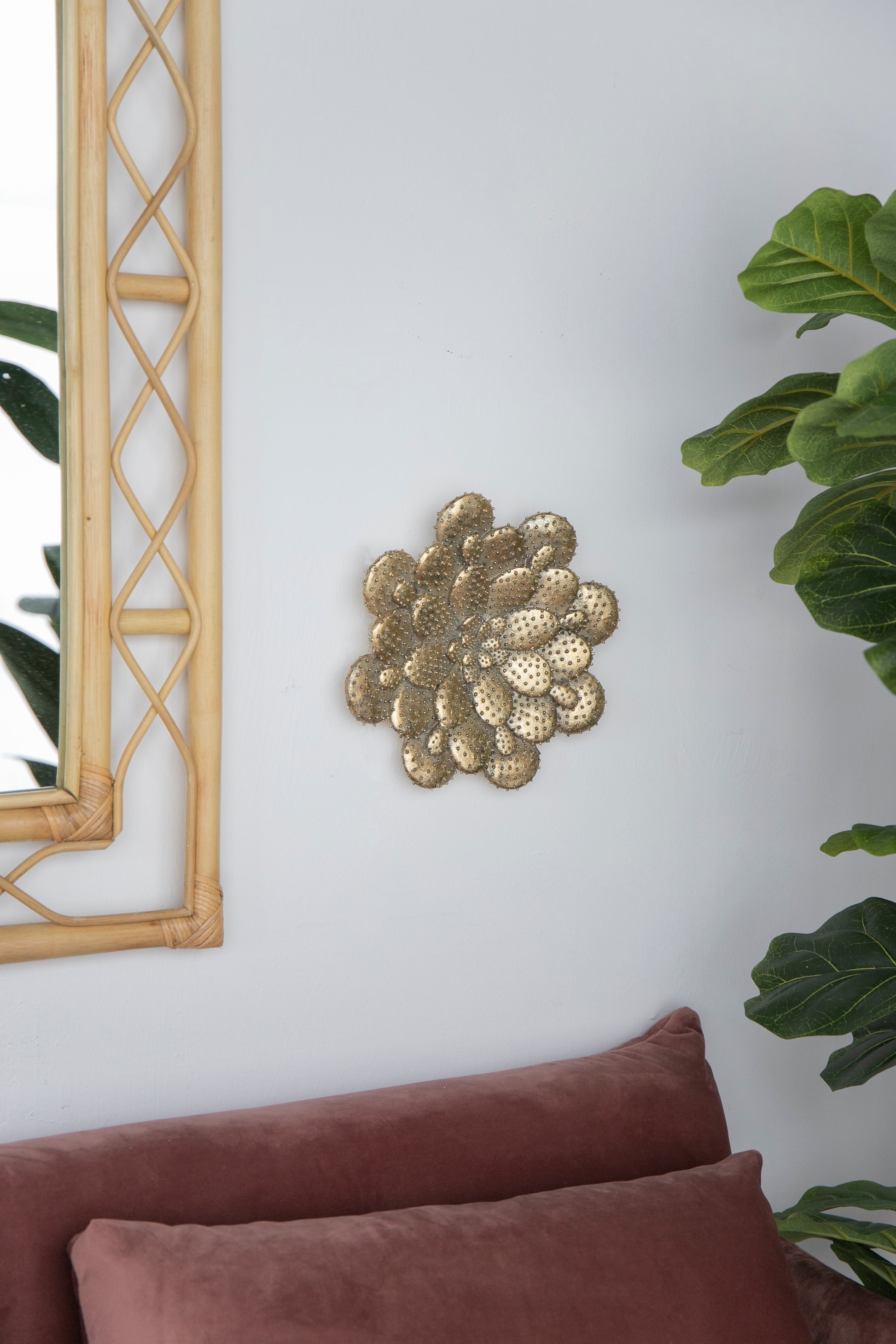 Antique brass cactus wall art textured with raised dots complements bohemian decor