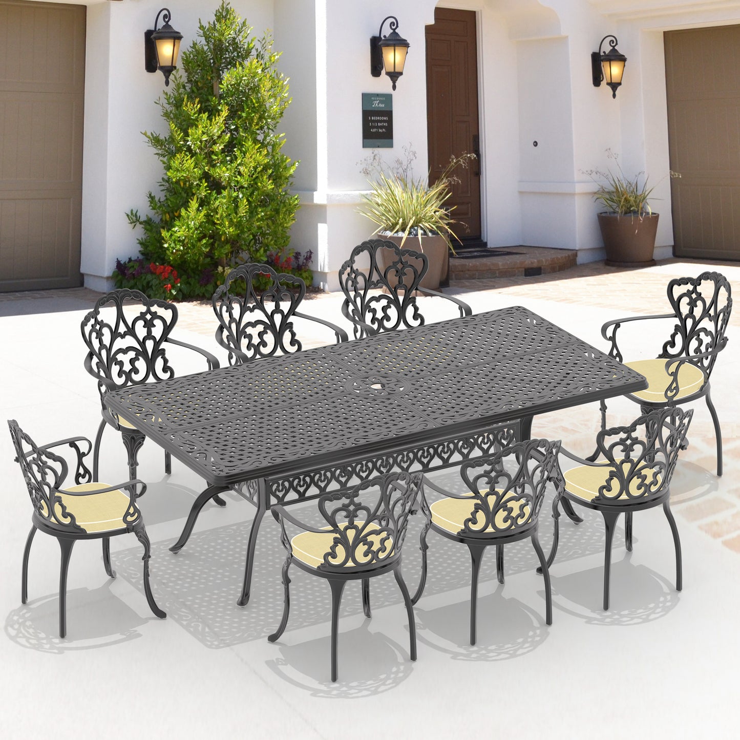 Ornate black cast aluminum patio dining set with eight chairs and yellow cushions