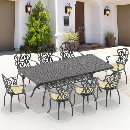 Ornate black cast aluminum patio dining set with eight chairs and yellow cushions