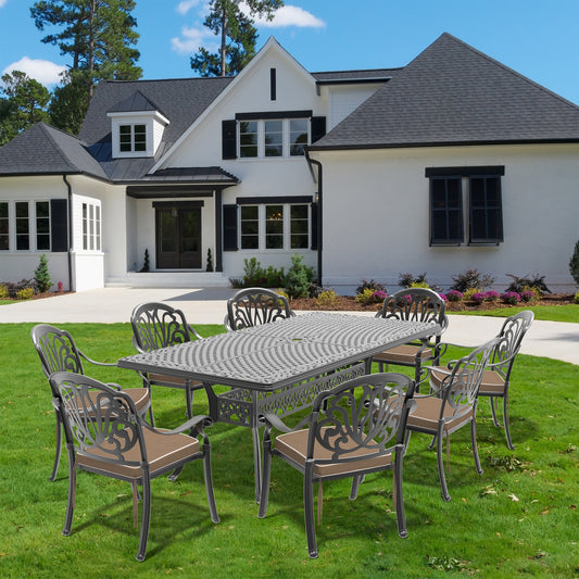 Ornate cast iron patio dining set with  chairs and rectangular table on a manicured lawn