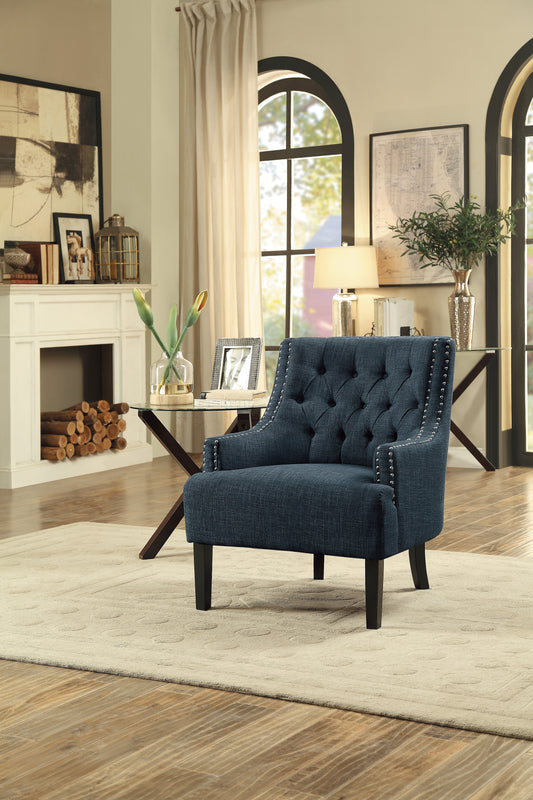 Dark blue tufted accent chair with silver nailhead trim perfect for living rooms