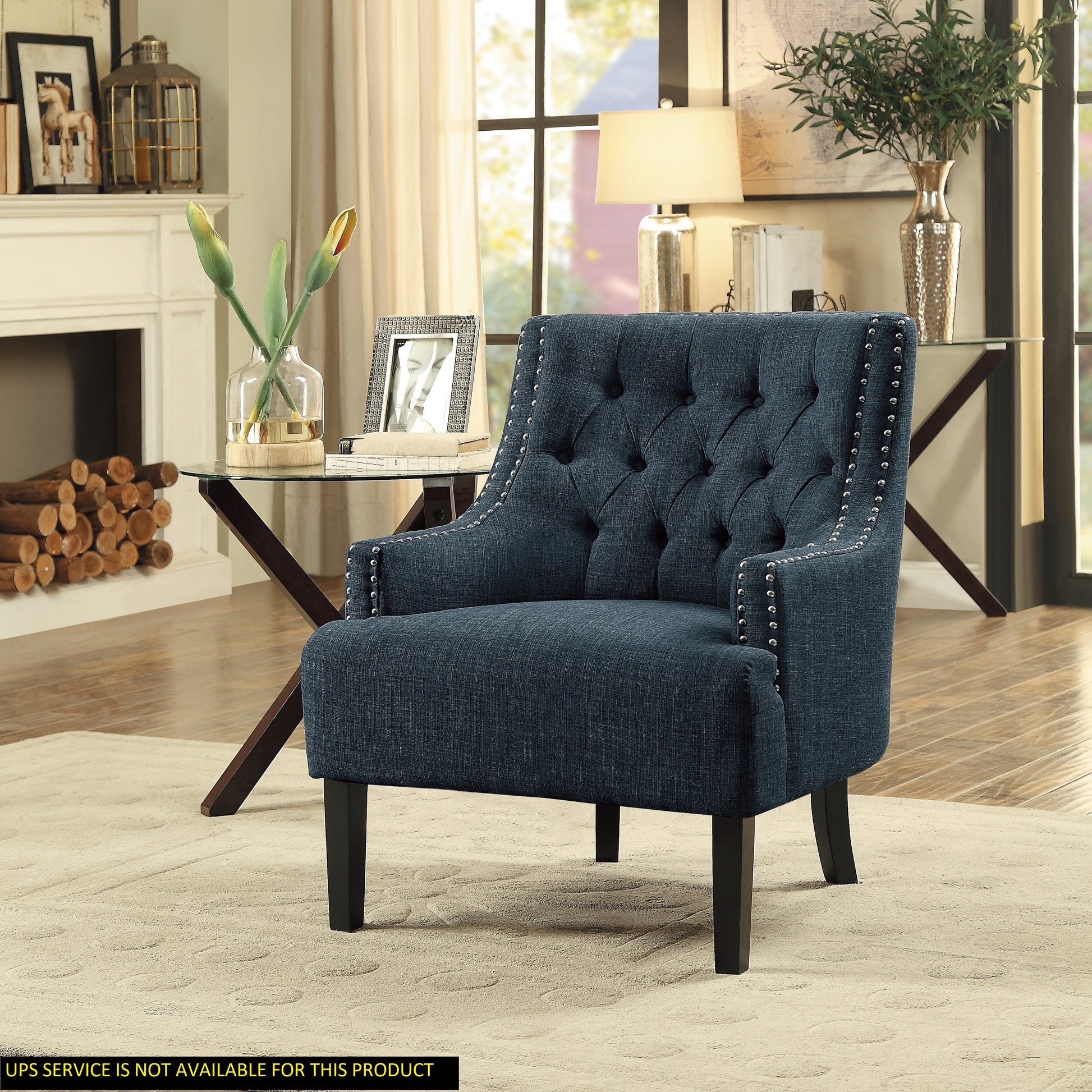 Navy blue upholstered accent chair with diamond tufting and silver nailhead trim