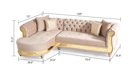 Tufted beige velvet sectional sofa with gold accents and decorative pillows