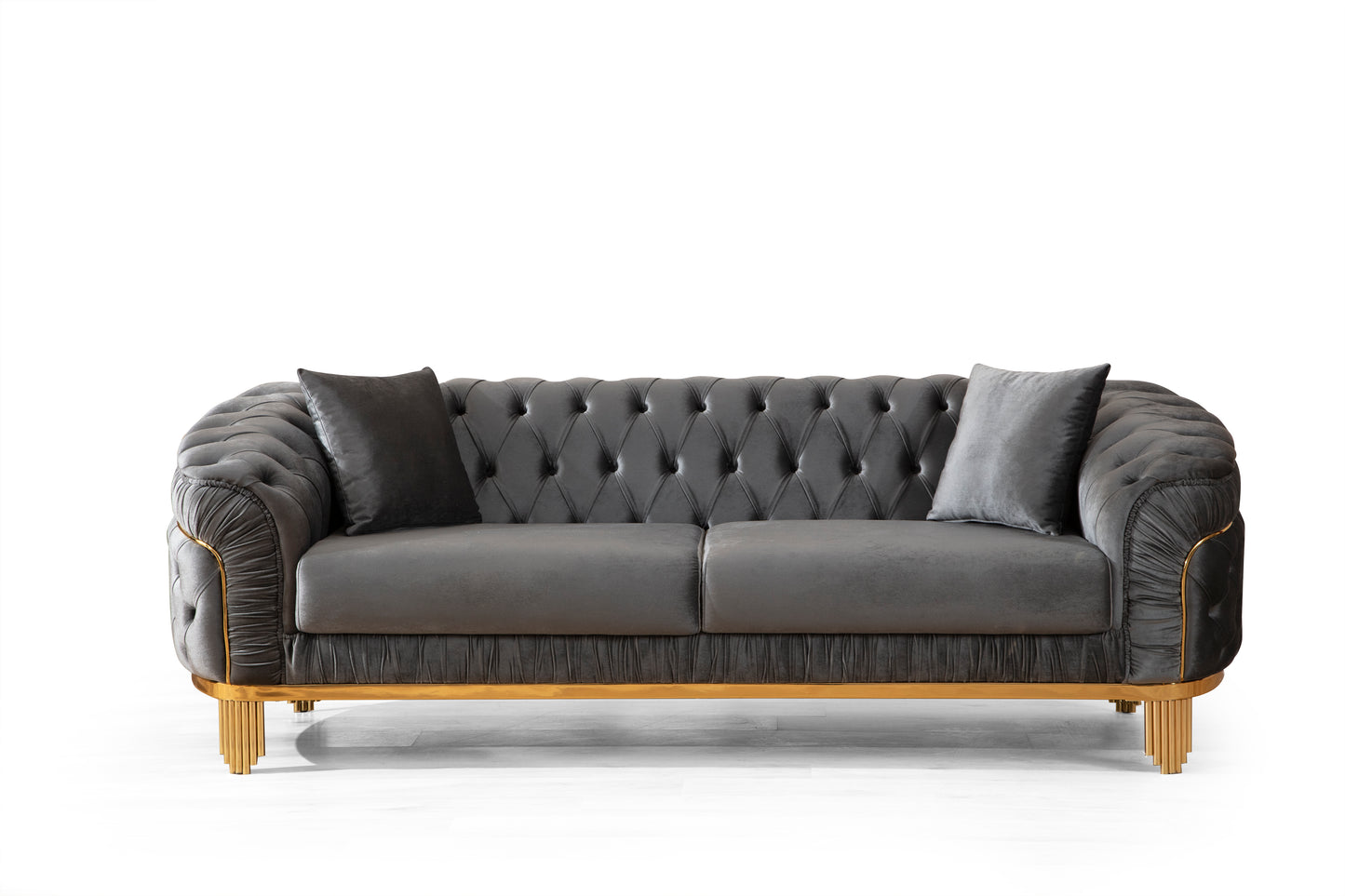 Elegant dark grey velvet chesterfield sofa with gold accents and decorative tufting