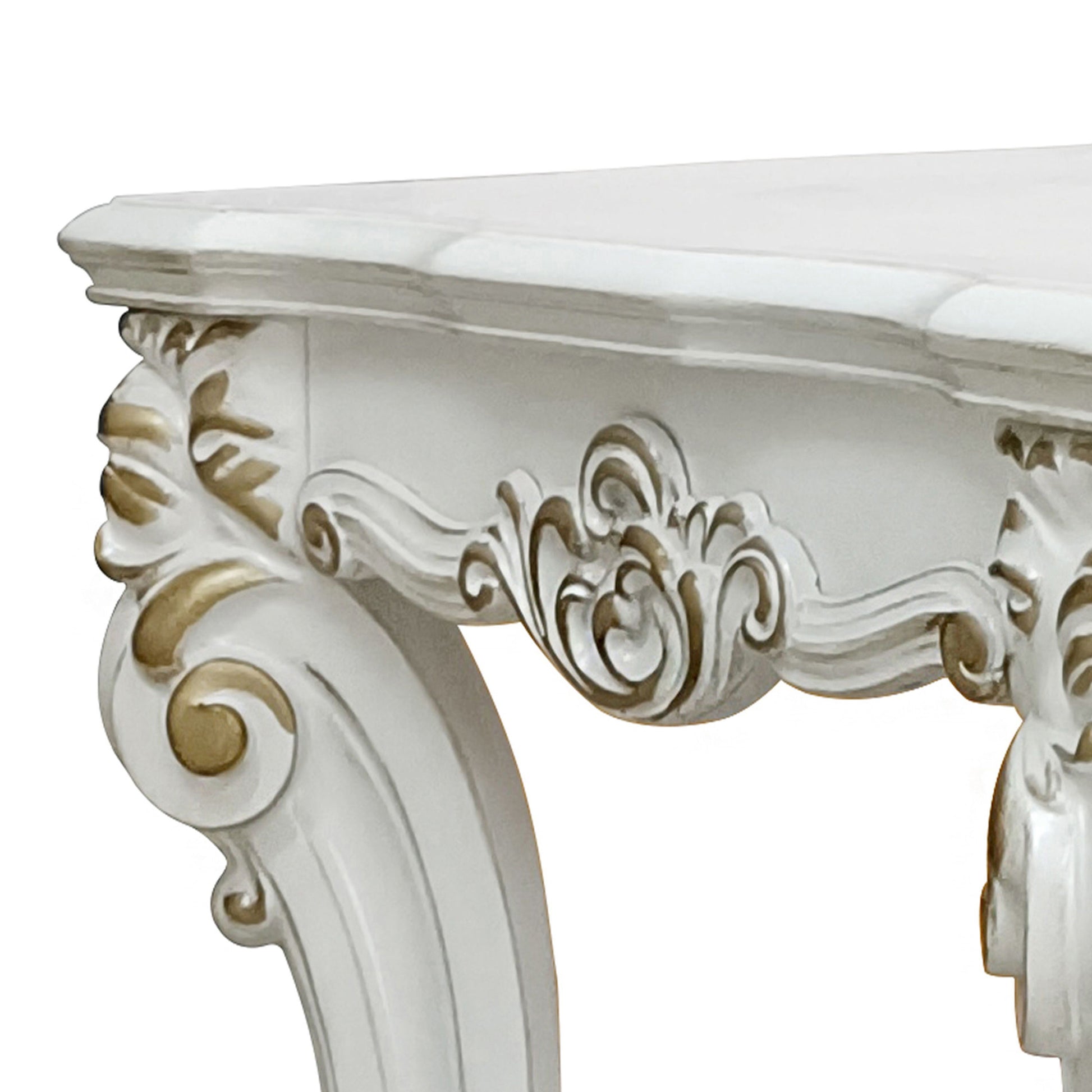 White ornate console table with gold accents on carved legs