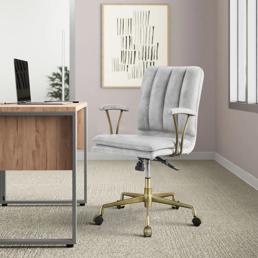 Light gray upholstered office chair with channel tufting and brass accents perfect for a stylish desk setup
