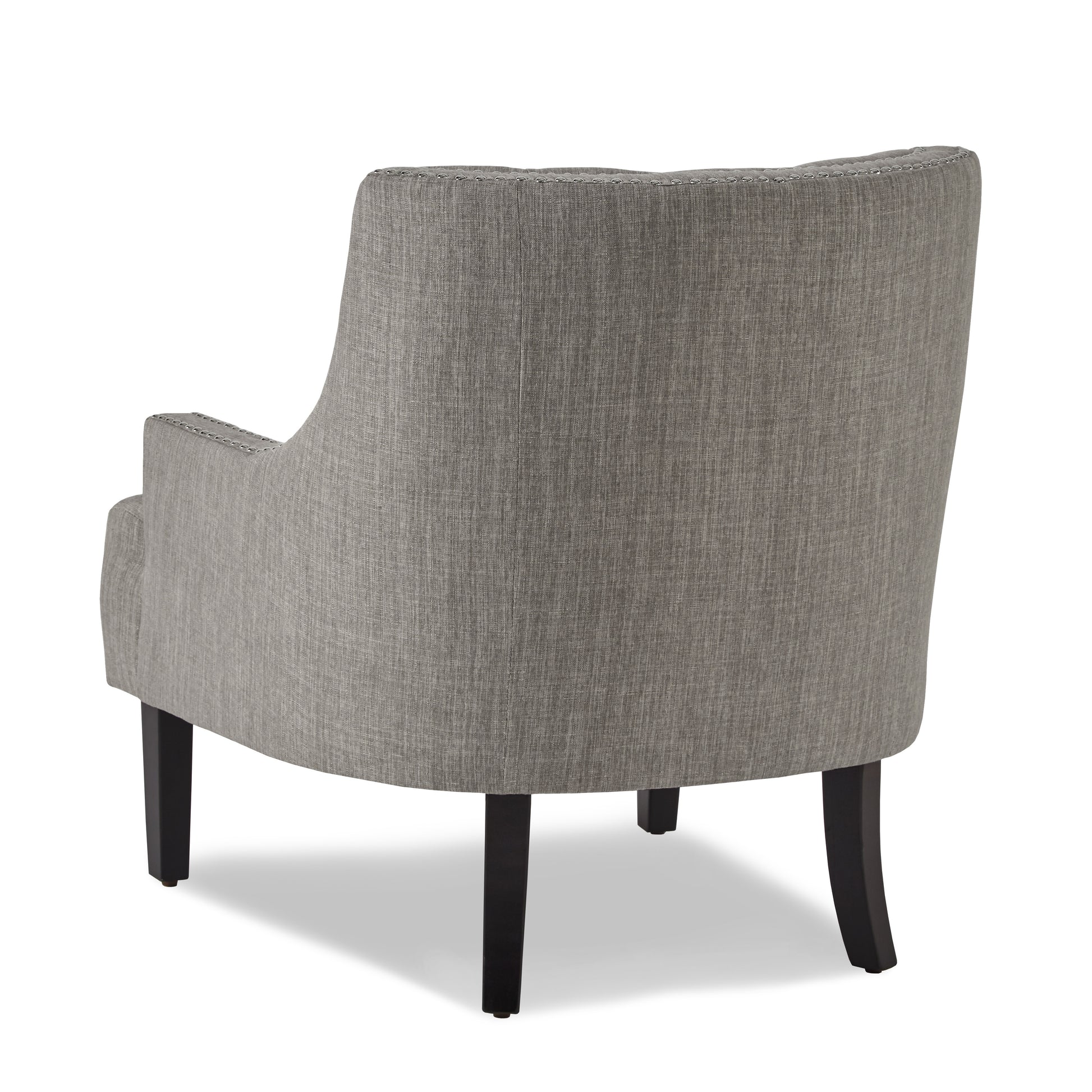 Back view of gray upholstered accent chair with studded trim and dark wood legs