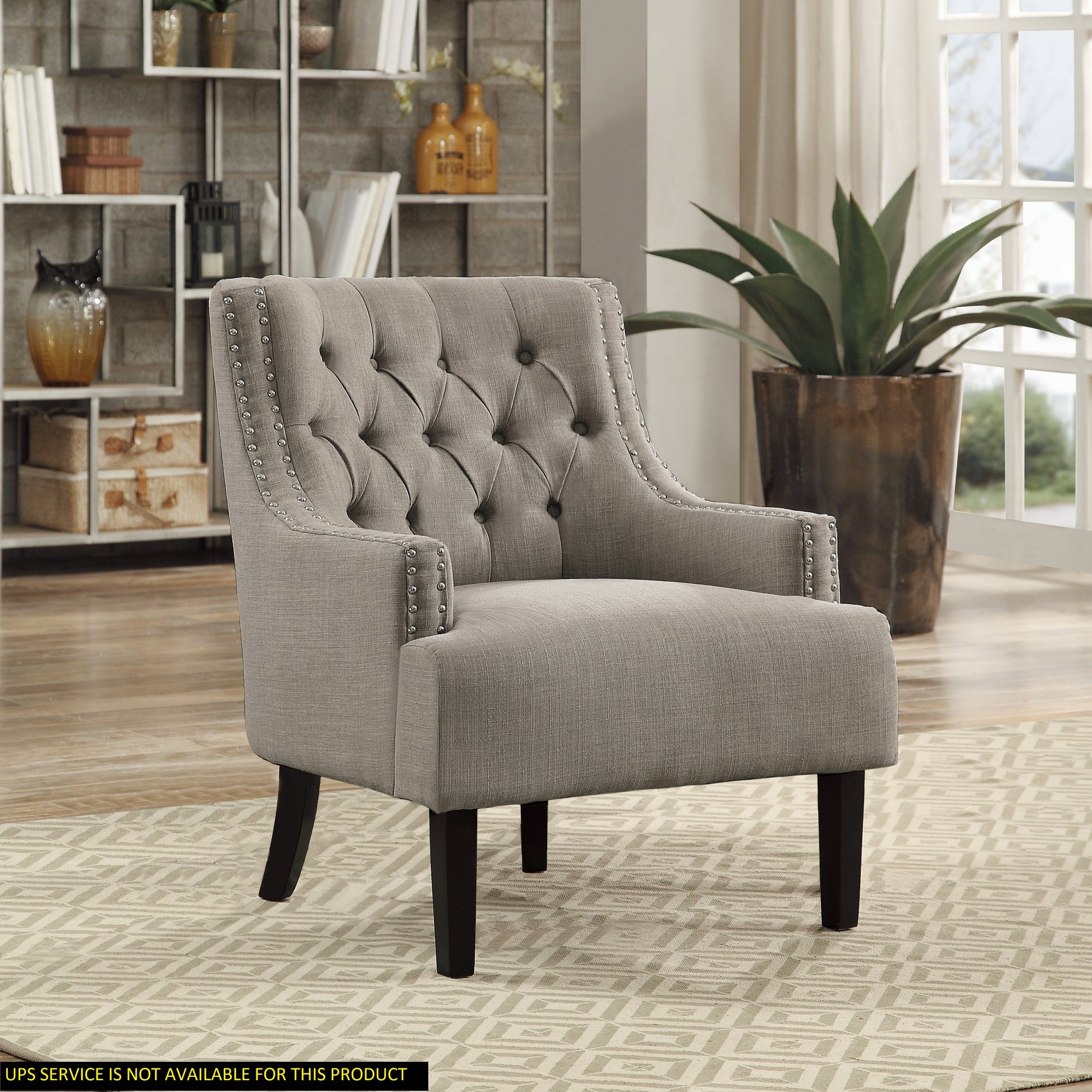 Tufted grey linen accent chair with silver nailhead trim perfect for reading nooks