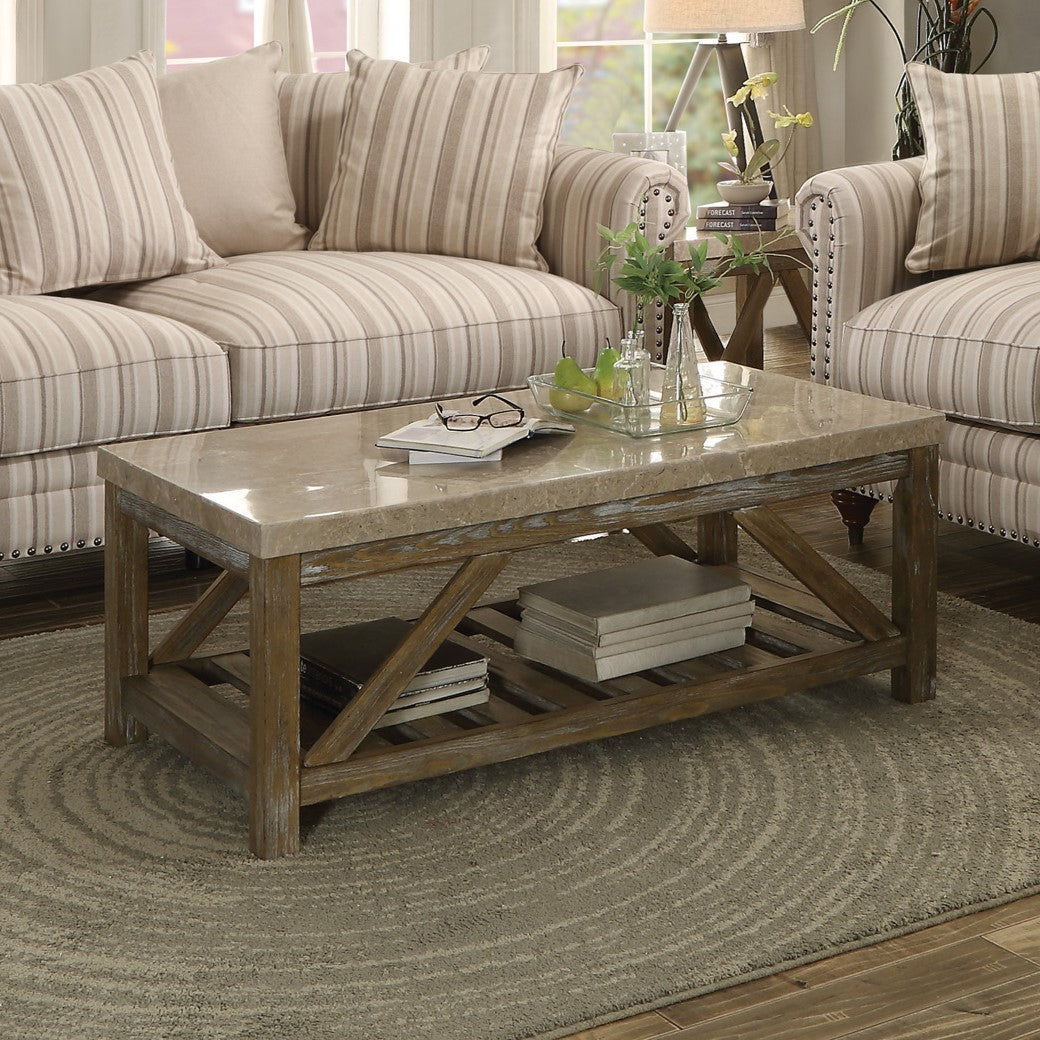 Distressed wood coffee table with marble top and lower shelf storing books