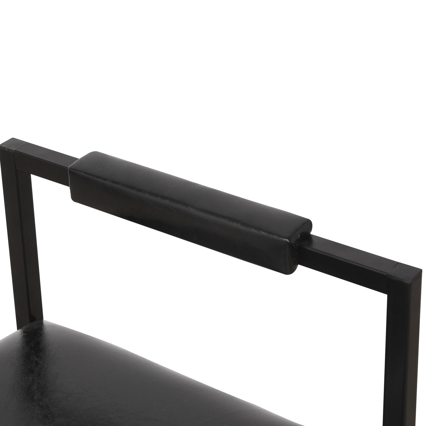 Closeup of a black faux leather armchair armrest with metal frame