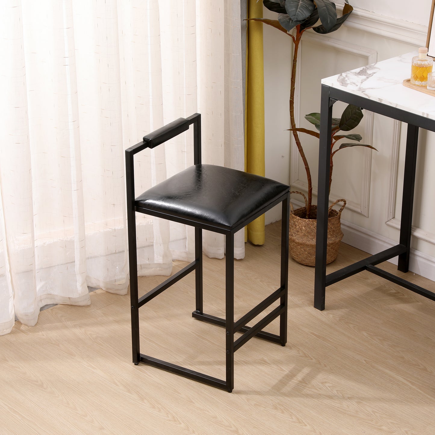 Black faux leather bar stool with a minimalist black metal frame