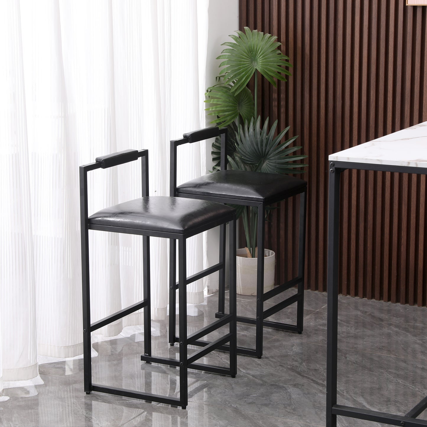 Black leather upholstered bar stool with a modern metal frame and armrests