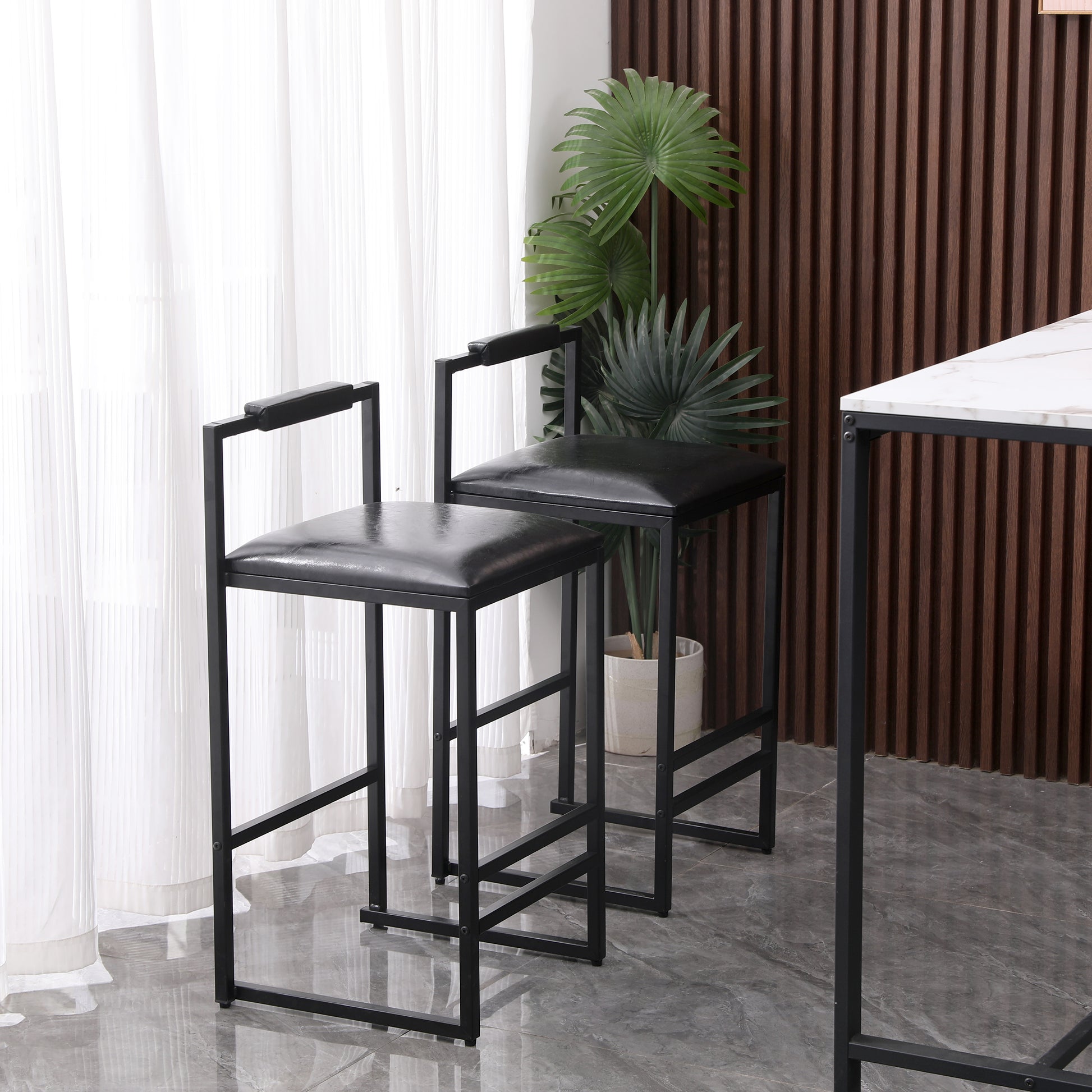 Black leather upholstered bar stool with a modern metal frame and armrests