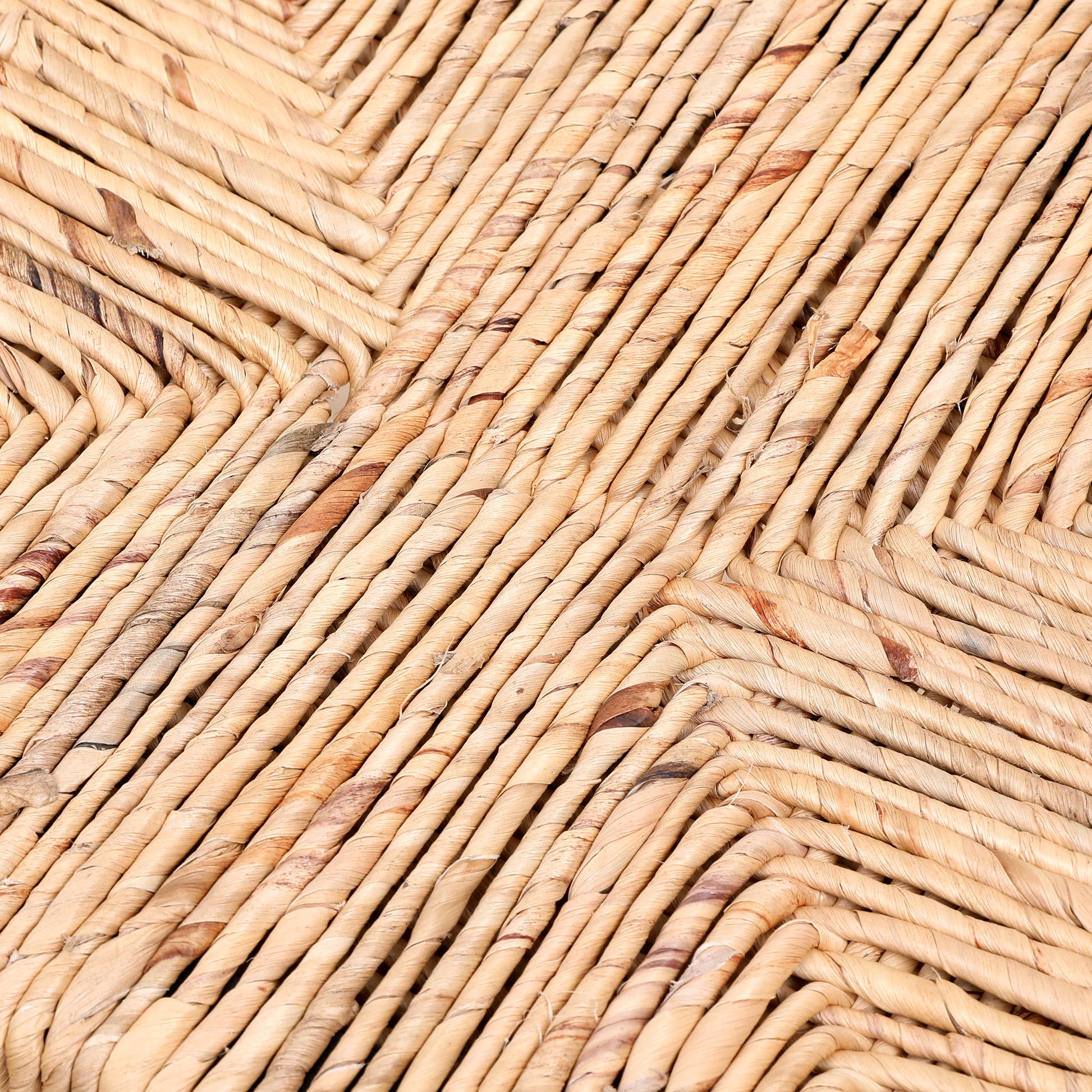 Closeup of woven natural jute rope forming a diamond pattern texture