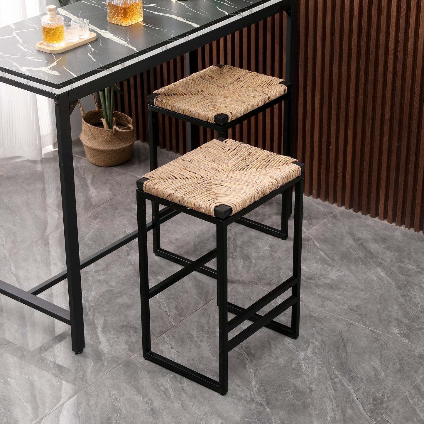 Woven natural raffia bar stool with a black metal frame perfect for modern kitchens