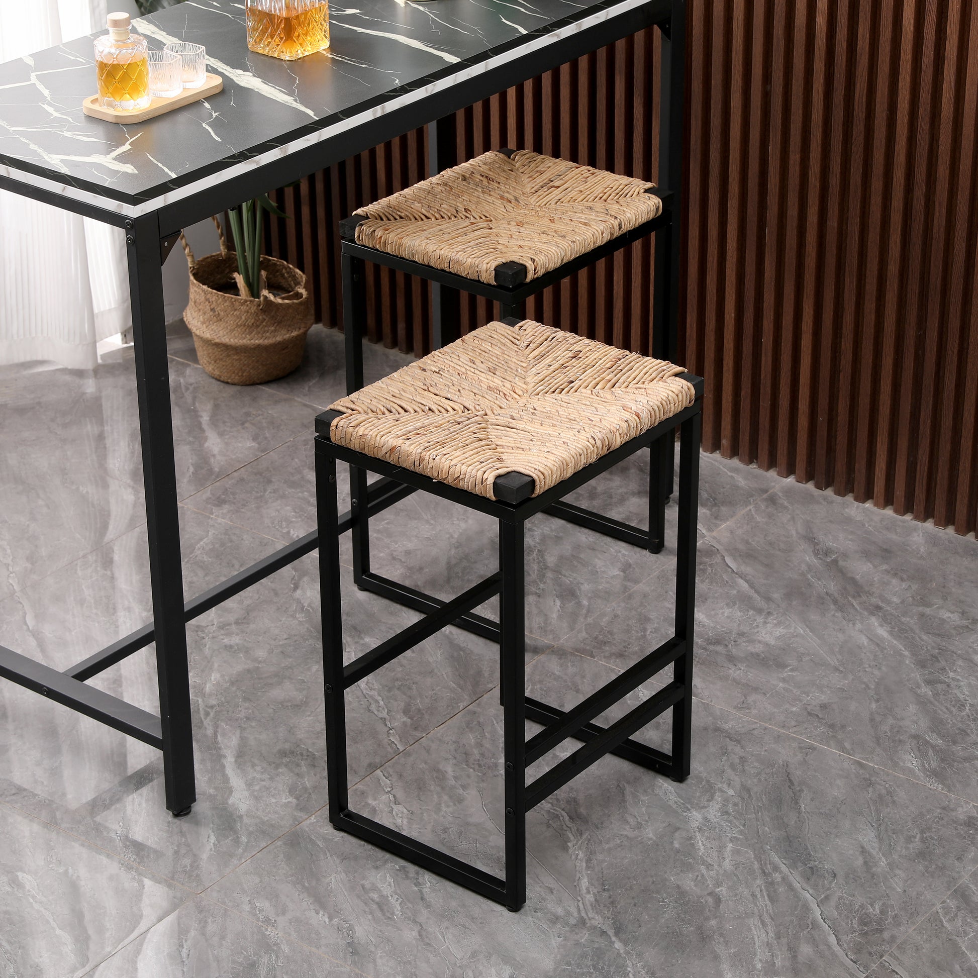 Woven natural raffia bar stool with a black metal frame perfect for modern kitchens