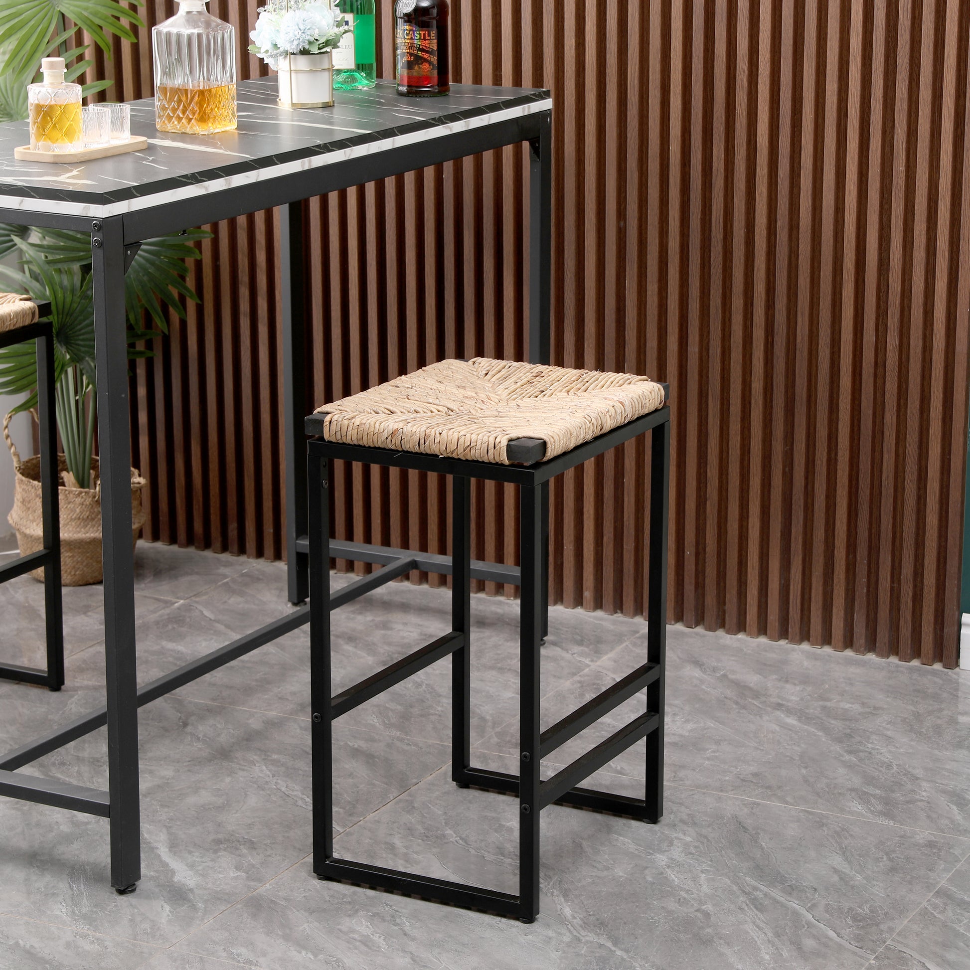 Woven seagrass seat bar stool with black metal frame adding natural texture to modern spaces
