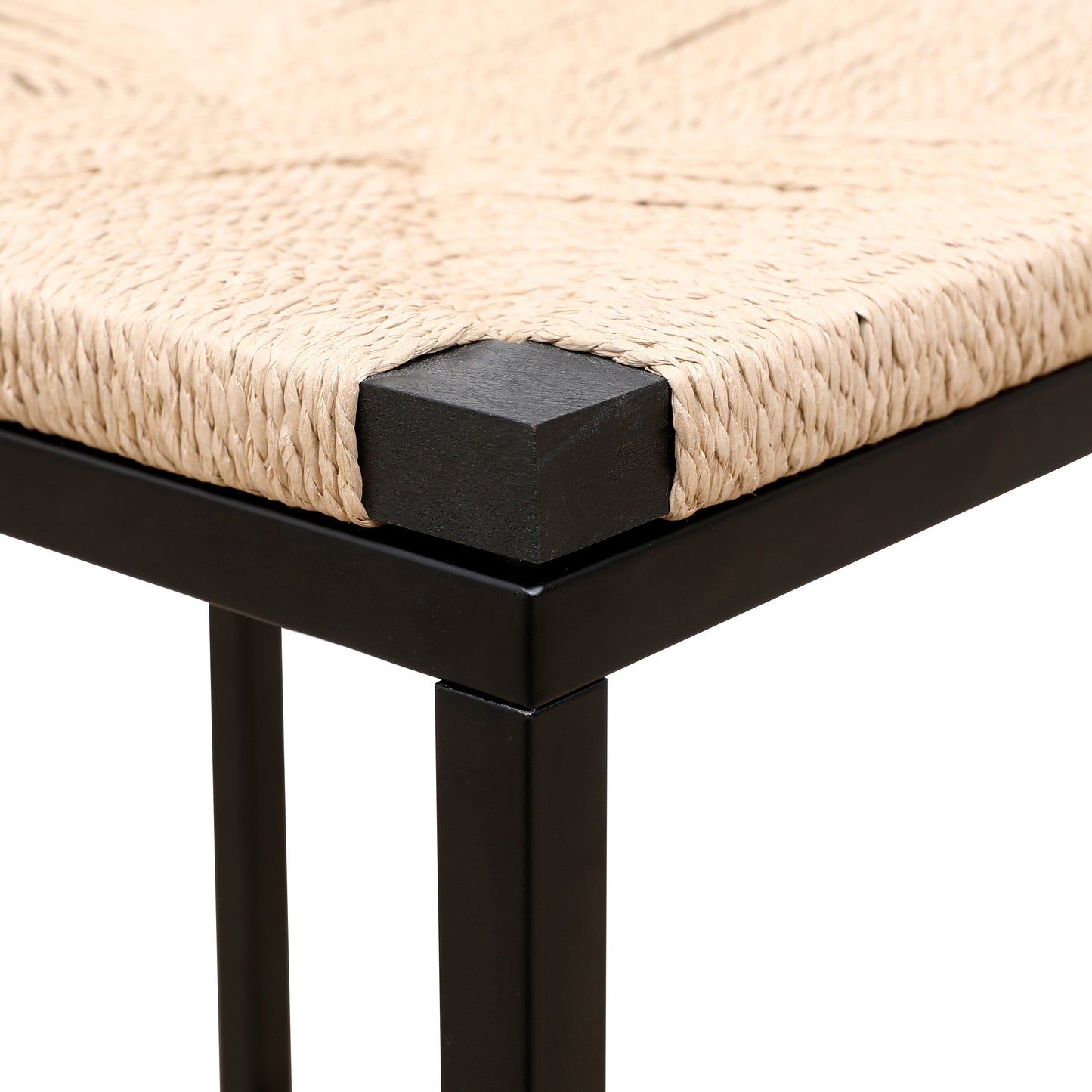 Closeup of a natural woven rush seat bench with a black metal frame