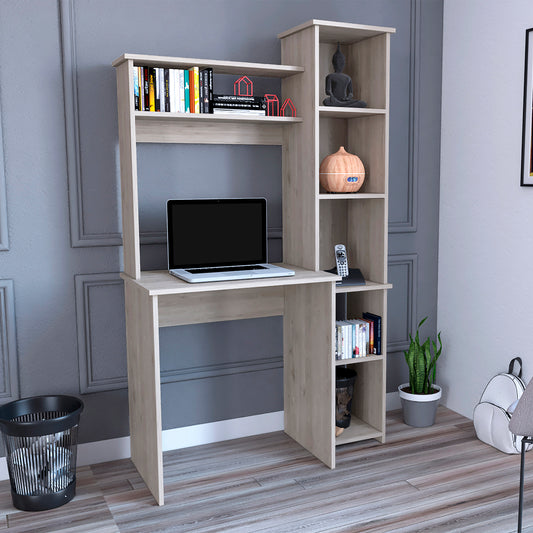 Modern light wood computer desk with attached shelving and a laptop